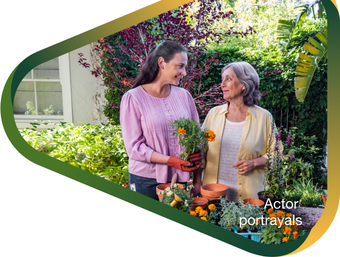 Actor portrayal of adult daughter potting flowers with elderly mother in her backyard, who has agitation that may happen with dementia due to Alzheimer's disease.