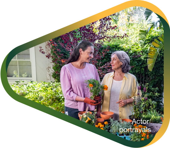 Actor portrayal of adult daughter potting flowers with elderly mother in her backyard, who has agitation that may happen with dementia due to Alzheimer's disease.